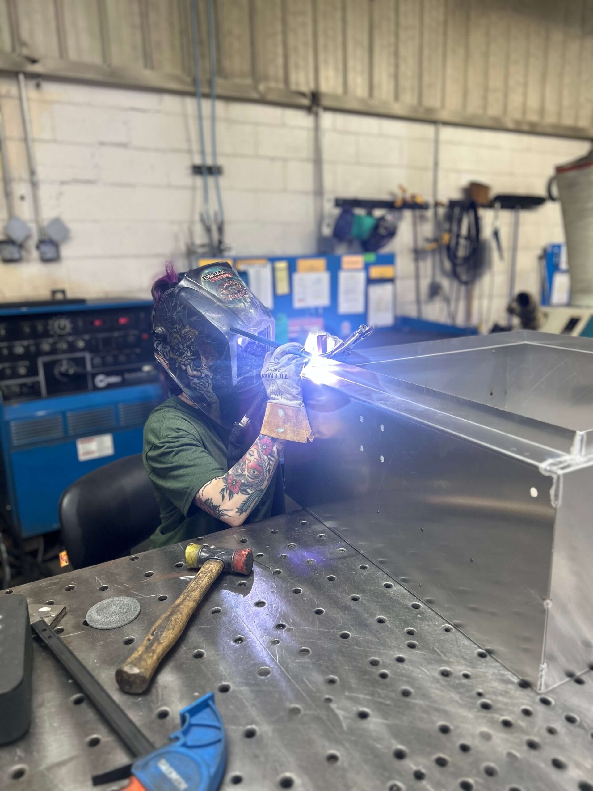 man welding sheet